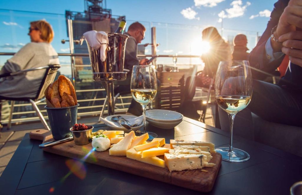 people enjoy drinks on a rooftop bar in lisbon