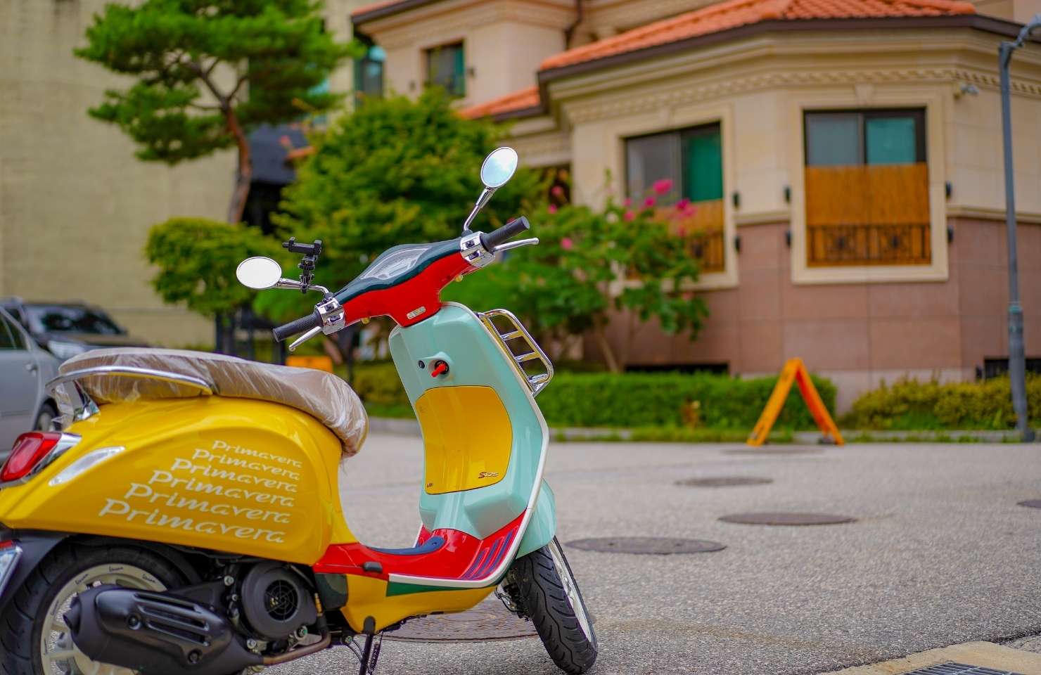 an Italian Vespa in front of a house