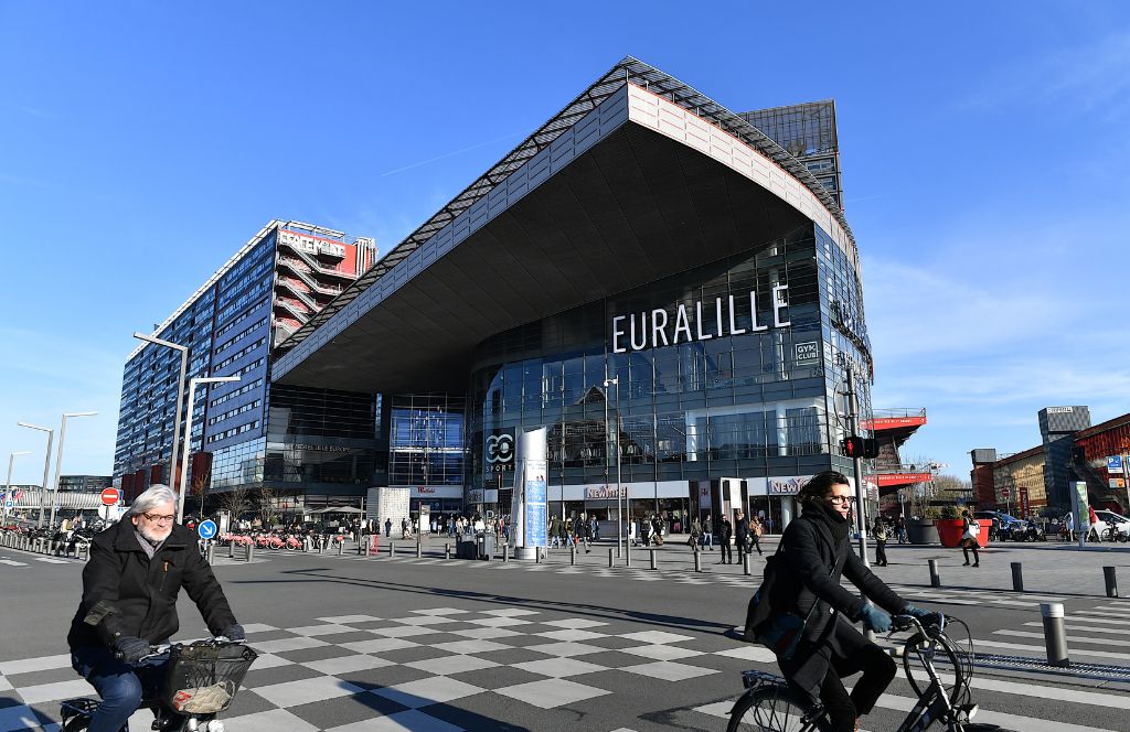 a cyclist speeds past the lille station during a weekend in lille