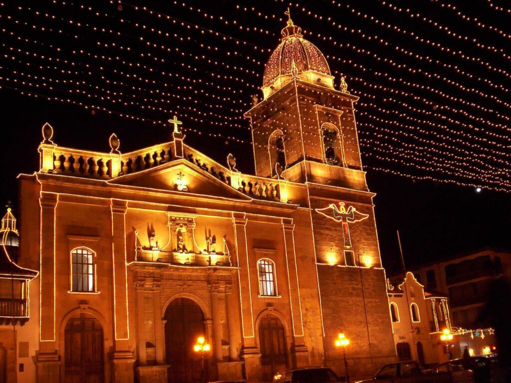 a church at night in colombia with christmas decorations - one of the most unique christmas destinations
