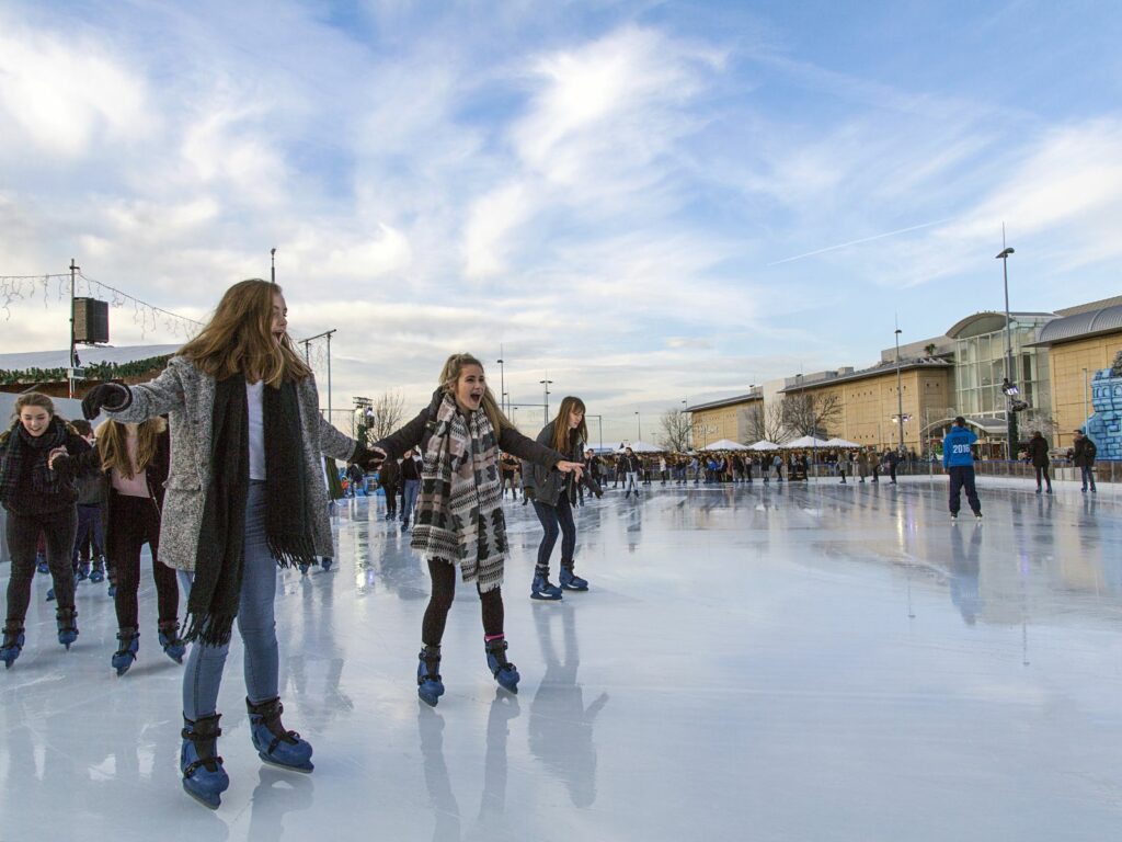people ice skating on an ice rink in bristol