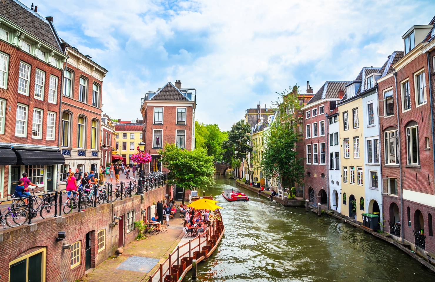 Cyclists looking onto the Utrecht canals and bars and restaurants 