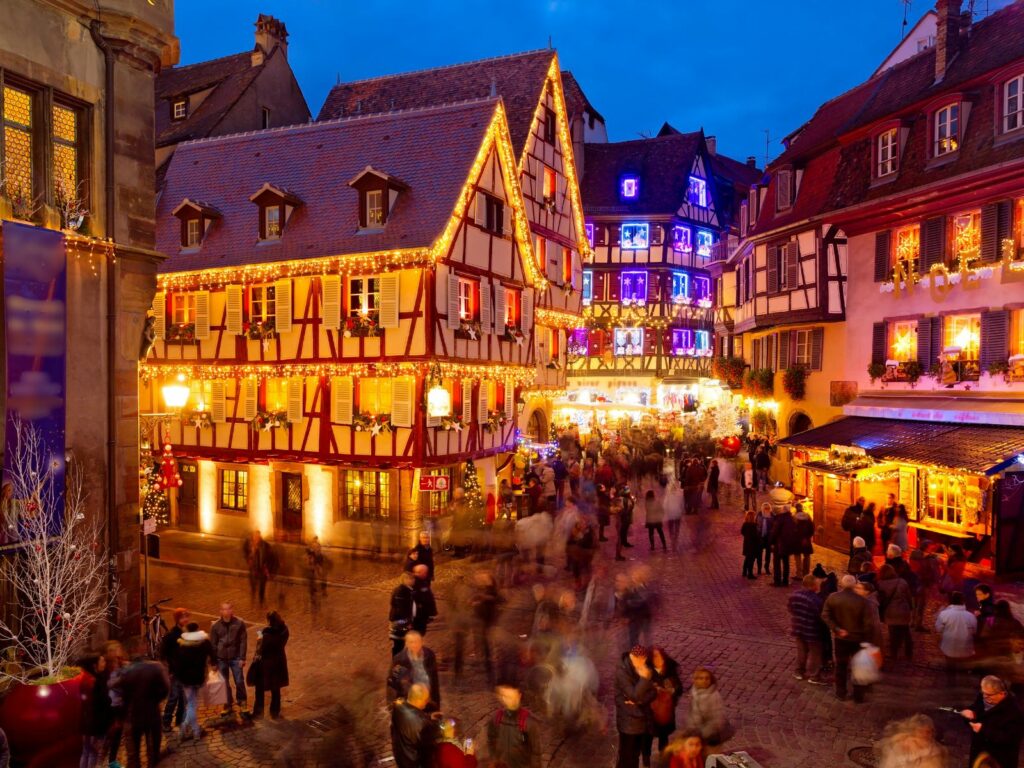 people in the street celebrate christmas in france