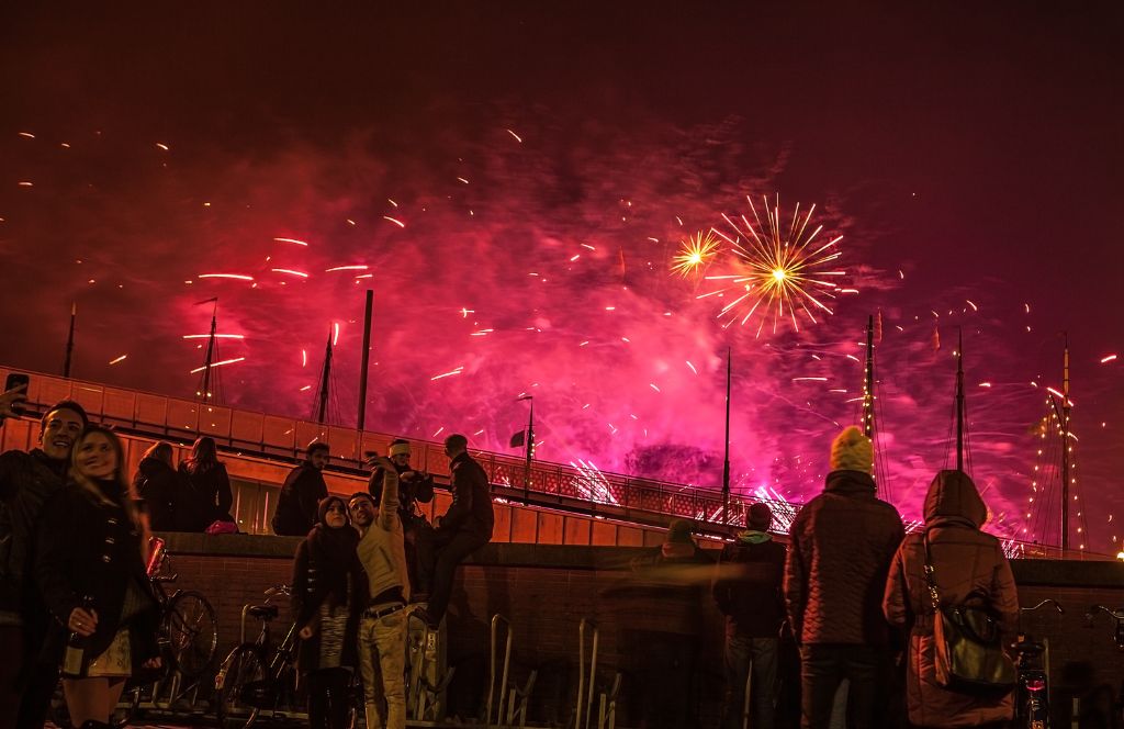 people watching fireworks in amsterdam on new year