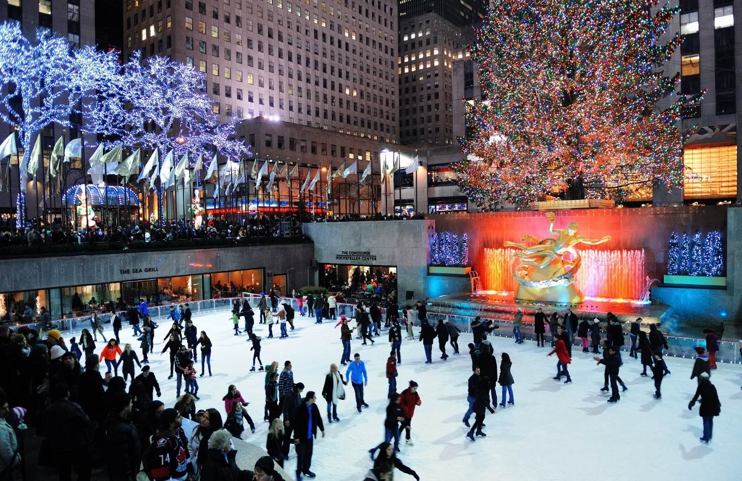 people ice skating at the rockefeller center new york