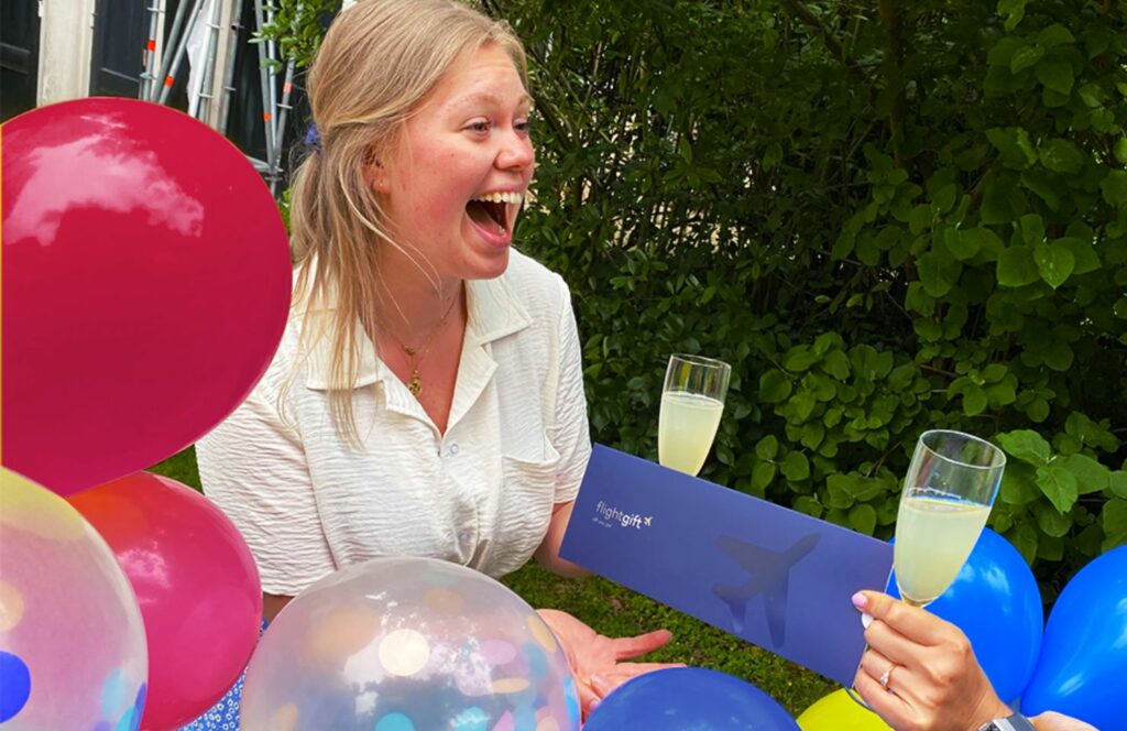 woman being gifted a flightgift card as a summer birthday gift