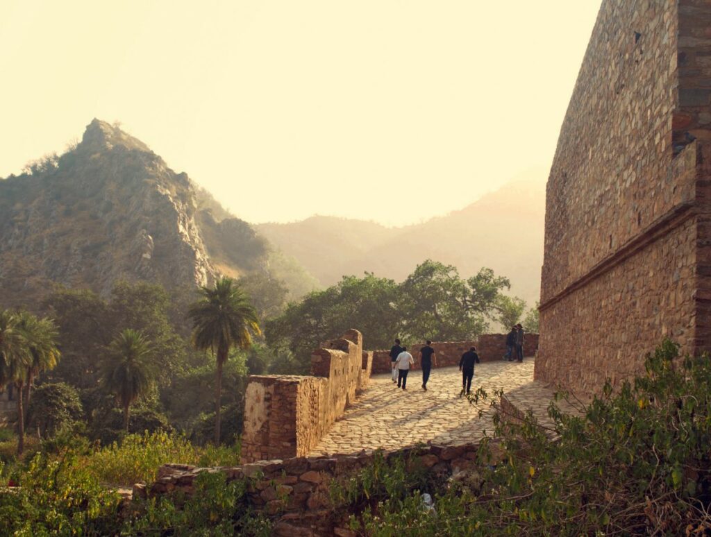 Bhangarh Fort, India bij zonsondergang met twee mensen op verkenning