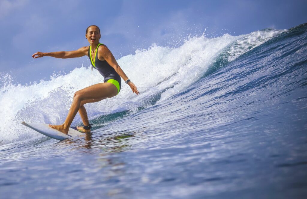 a woman surfs the waves