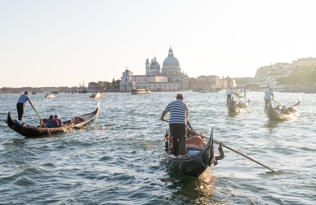 a couple in venice on a gondola as part of a romantic Valentine's Day getaway