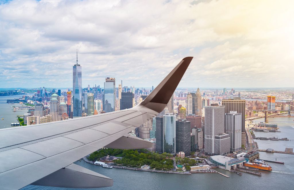 a plane flies over new york city