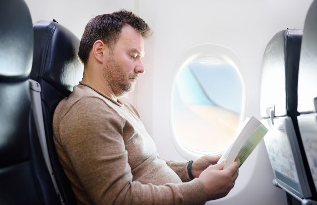 a man on a plane for his 60th birthday holiday