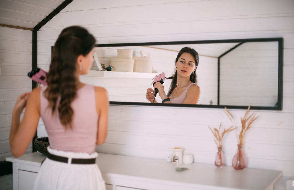 a girl uses her luxury hair styler