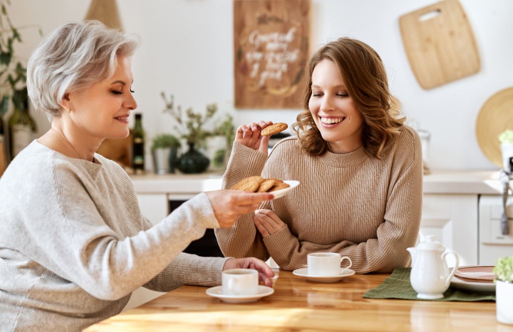 mom and daughter eat breakfast and drink coffee on mothers day