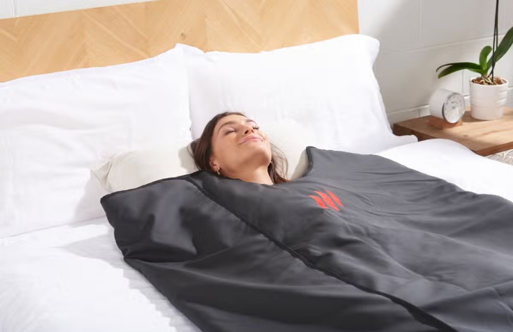 a woman enjoys a sauna blanket as her luxury 18th birthday gift