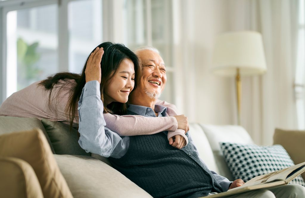 a woman gives her dad a personalised fathers day gift for 2024