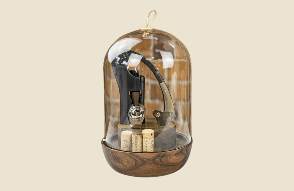 a glass dome with a corkscrew and corks inside is one of the most unique 60th birthday gifts for men