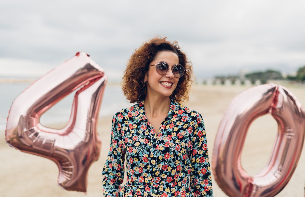 a lady on the beach who has been given one of the best 40th birthday presents for her