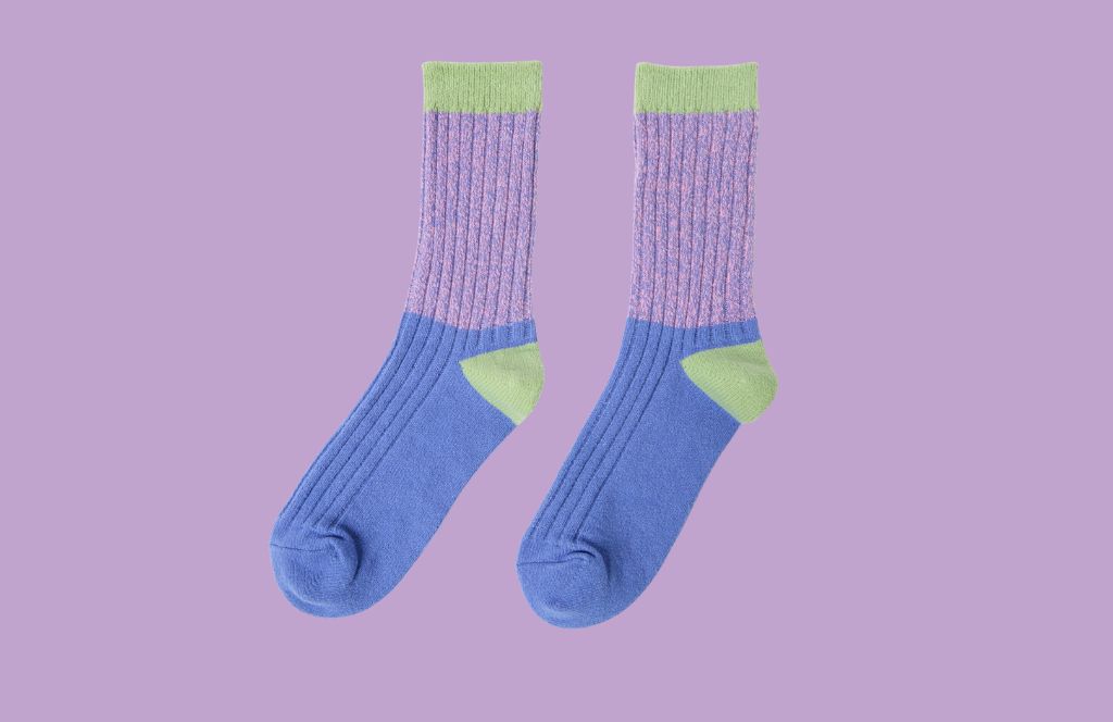a pair of purple and green socks given as one of the best 21st birthday gifts for her