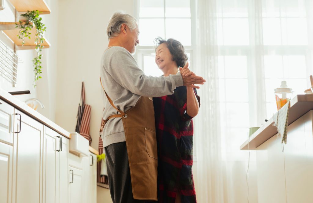 a couple on their 50th wedding anniversary dancing in the kitchen