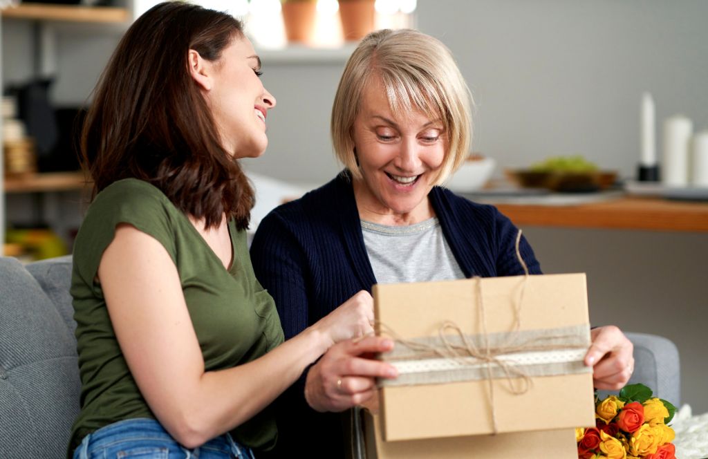 a woman is given one of the best retirement gifts for women by her colleague