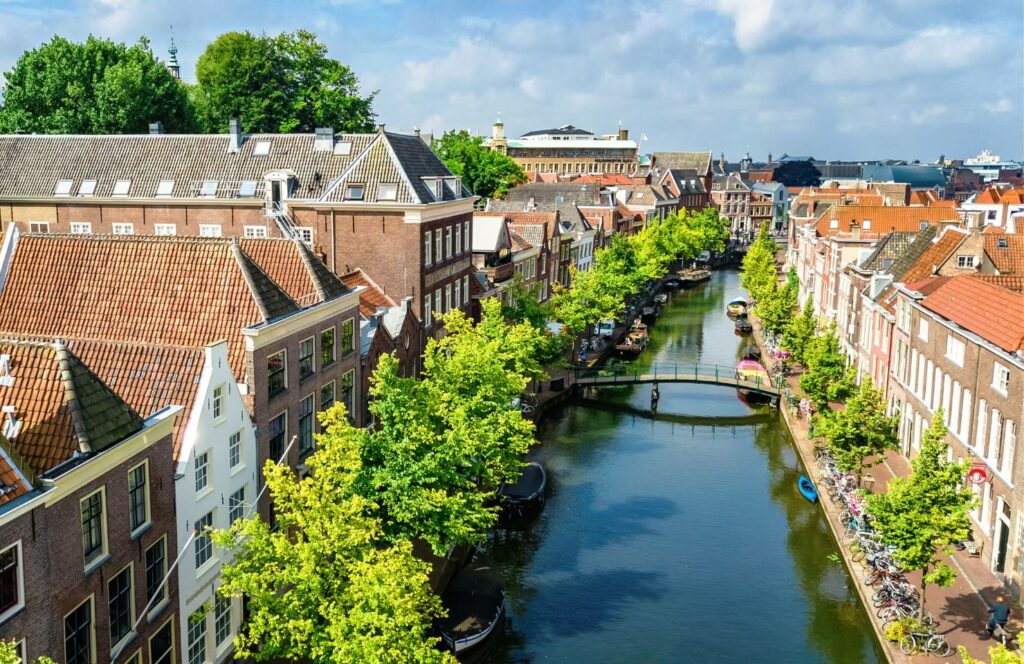 Leiden canals in the sun with traditional Dutch houses - one of the most beautiful dutch cities