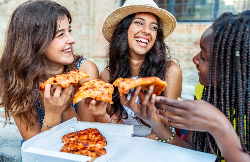 girls eat pizza on a food tour on a girls holiday