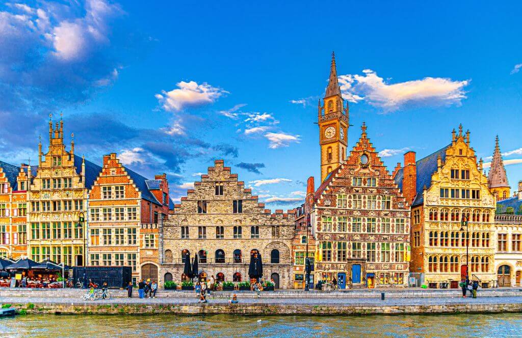 Scenic view of the historical city center of Ghent (Gent), Belgium. Beautiful cityscape with medieval architecture, monumental landmarks and Lys river with tourist boats, outdoor travel background