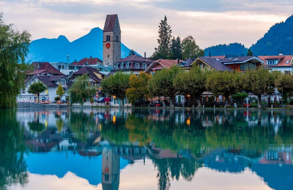 Interlaken, Switzerland, on the Aare River at dawn with river reflections.