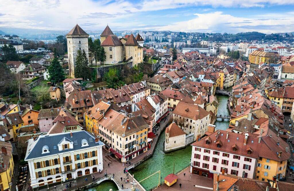 France travel and landmarks. Romantic beautiful old town of Annecy aerial drone view with medieval castle. Haute-Savoi region 